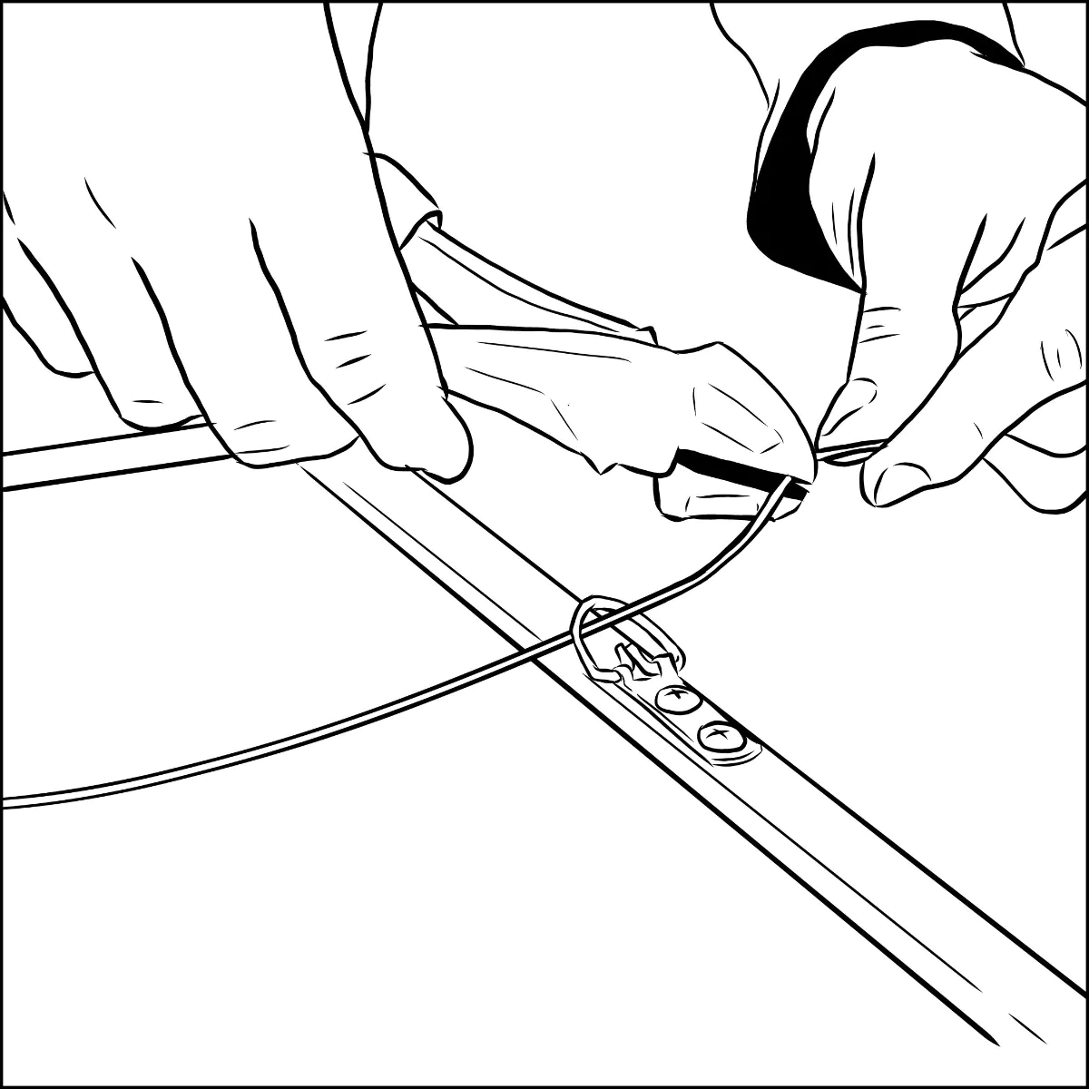 A hand threading picture wire through the second D-ring on the opposite side of the frame back, ready to trim the excess for the final wrap.